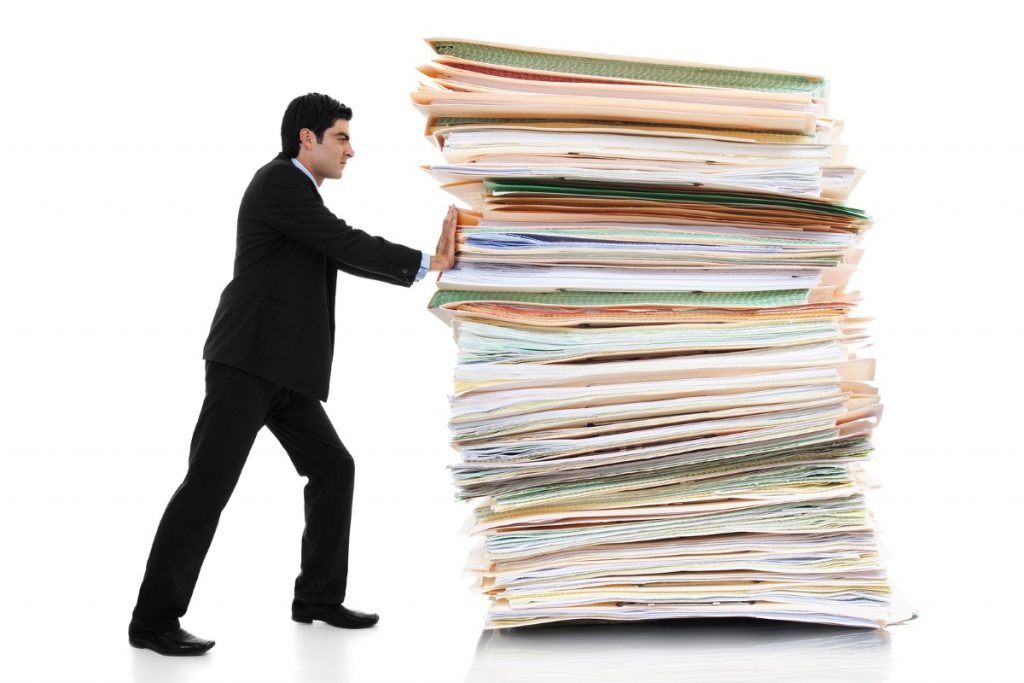 Affinity Diagrams - Man pushing a huge oversize stack of folders and paper