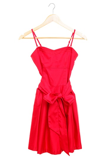 red dress with spaghetti straps hanging on a hangar against a white background - apparel store pos system