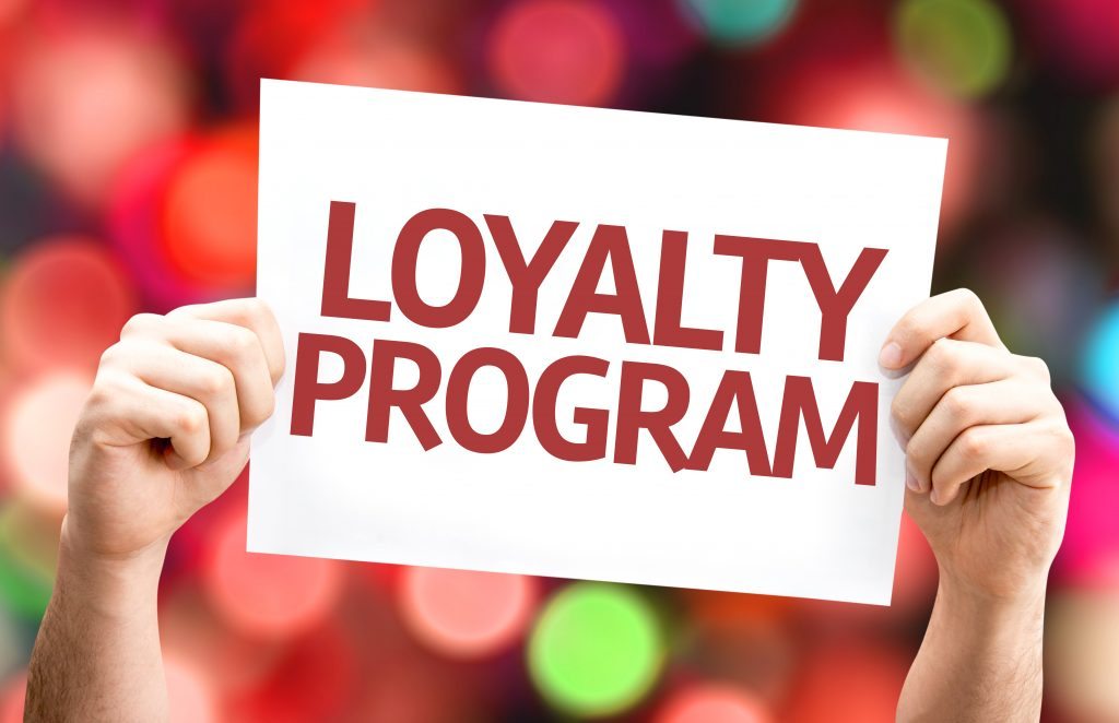 Best Loyalty Programs - picture of a person holding a sign that says "loyalty program"