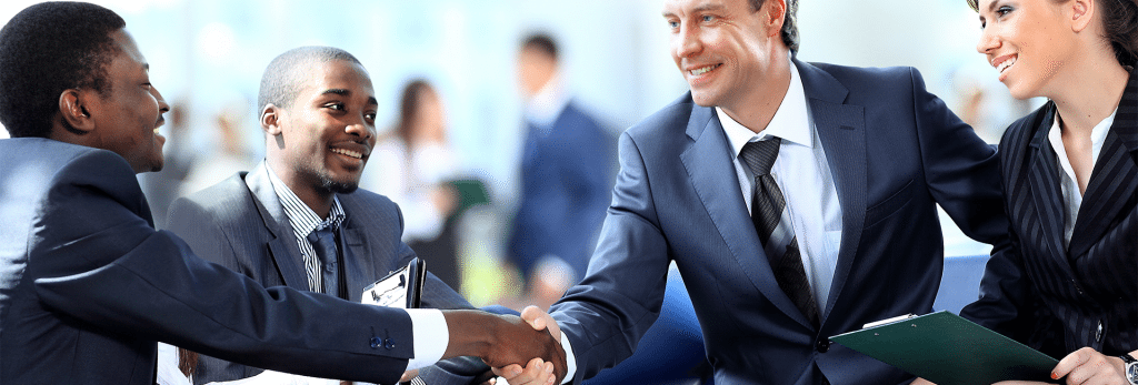 Online Credit Card Processing - Three business men and a business woman shaking hands and smiling