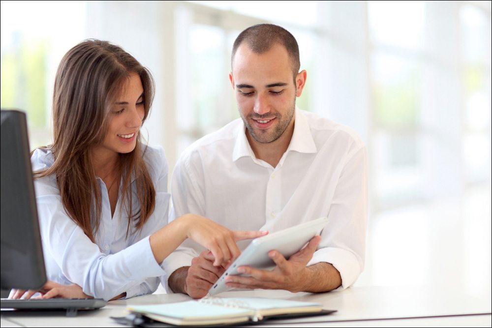 Online Payment Processing - Couple wearing white using a tablet