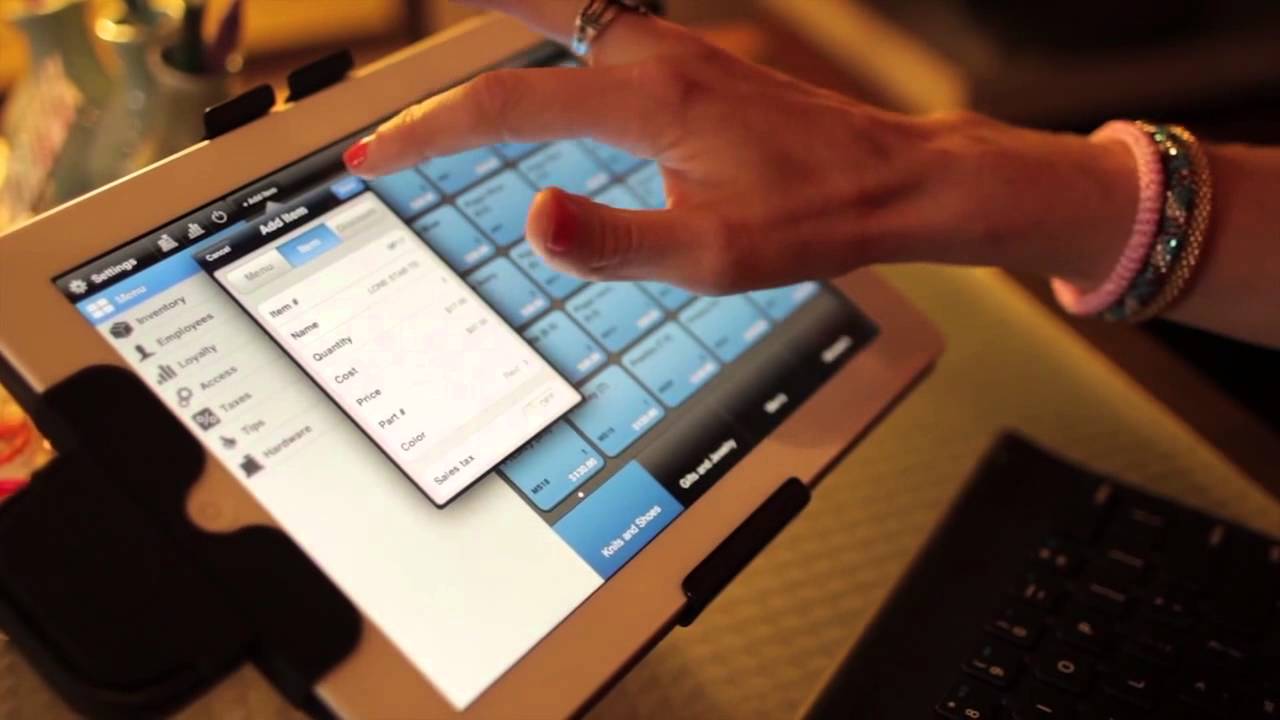 Point of Sale Systems - woman using a touchscreen tablet POS to ring up an order