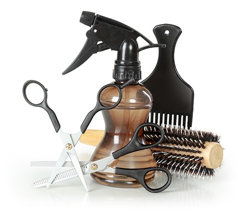 Hair cutting supplies against a white background; spray bottle, two scissors, comb and brush - salon barber POS system